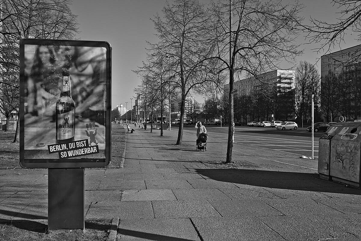Street view of the Karl-Marx-Allee in Berlin, with an advertisement billboard