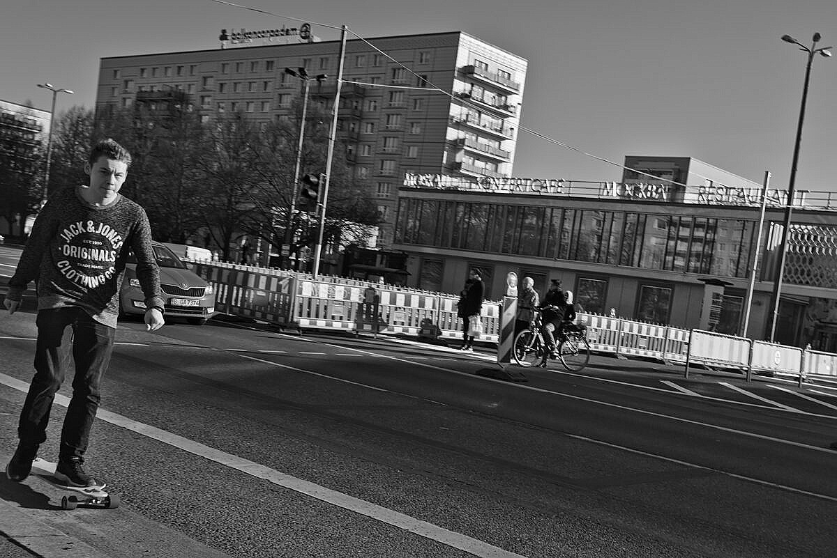 Karl-Marx-Allee, Berlin, with a kid of a skateboard.
