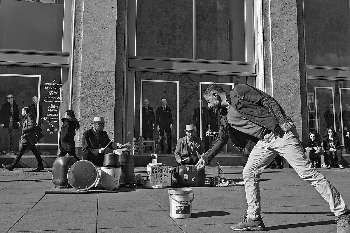 Alexanderplatz, Berlin, with street musicians and a man leaving them a bit of money