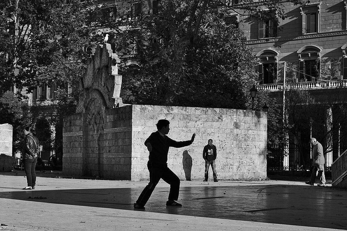 Man practising Tai Chi in a park on the Esquiline Hill in Rome.