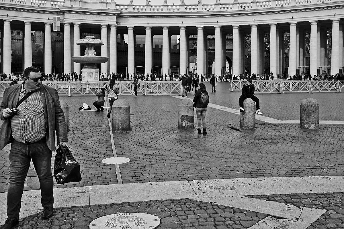 People mulling around in St. Peter's Square in Rome