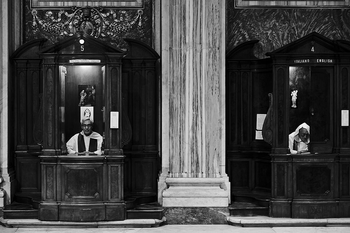 Priests taking confessions in the Basilica Santa Maria Maggiore in Rome.