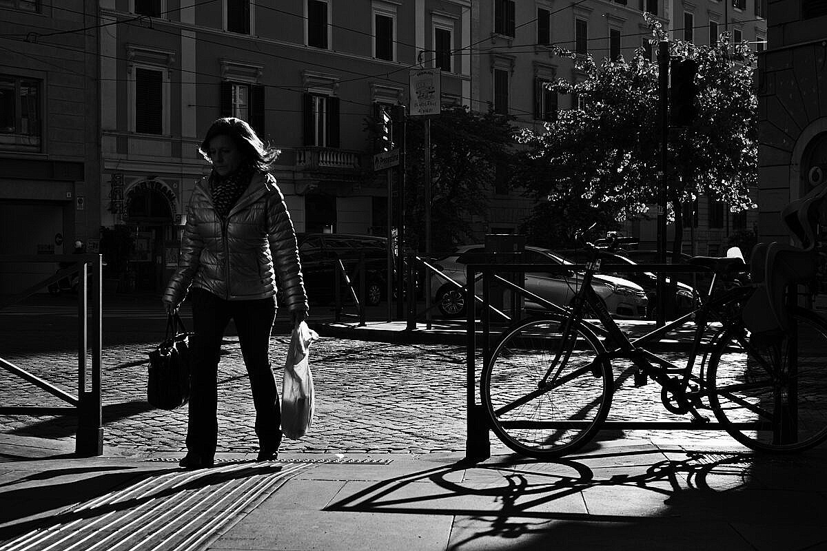 Street scene with woman and bicycles on the Esquiline Hill in Rome.
